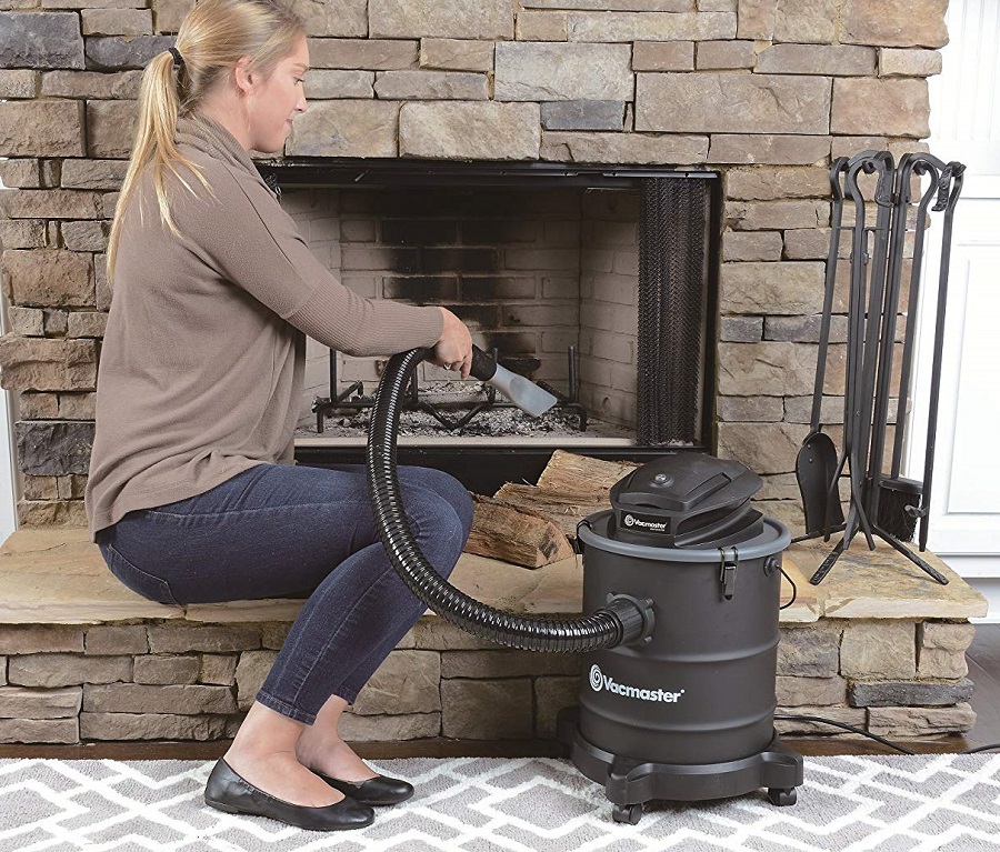 Cleaning fireplace with ash vacuum